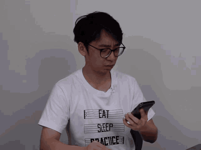 a man wearing glasses and a white shirt that says " fugue you "