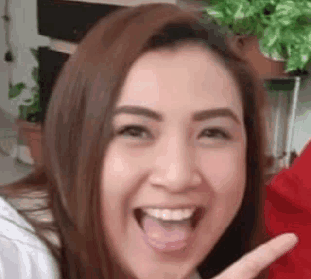 a close up of a woman 's face with her tongue out and smiling .