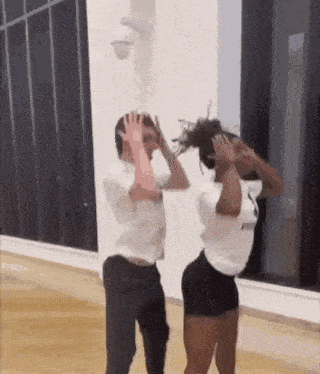 a man and a woman are dancing together in a dance studio