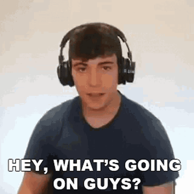 a young man wearing headphones is talking to someone .