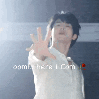 a man in a white shirt reaches out towards the camera with the words oomf here i com written below him