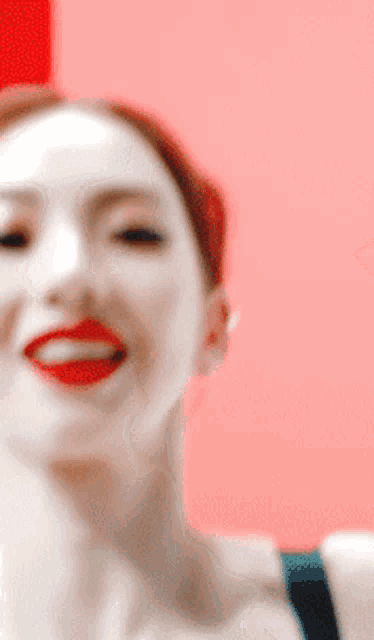a close up of a woman 's face with red lips