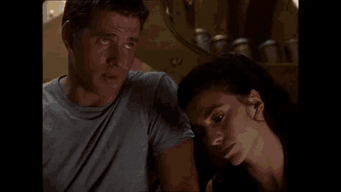 a man and a woman are looking at each other with their eyes closed