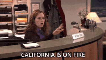 a woman sitting at a reception desk says california is on fire