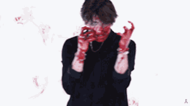 a person with blood on their hands and face