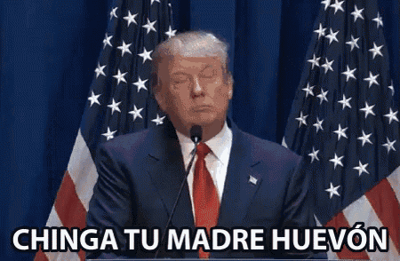 donald trump is giving a speech at a podium in front of american flags and says chinga tu madre huevon