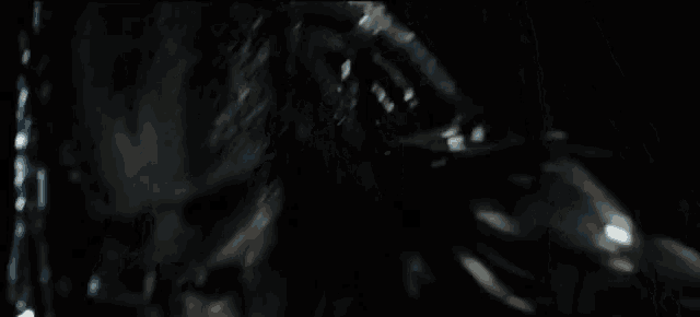 a close up of a predator with its tongue sticking out in the dark .
