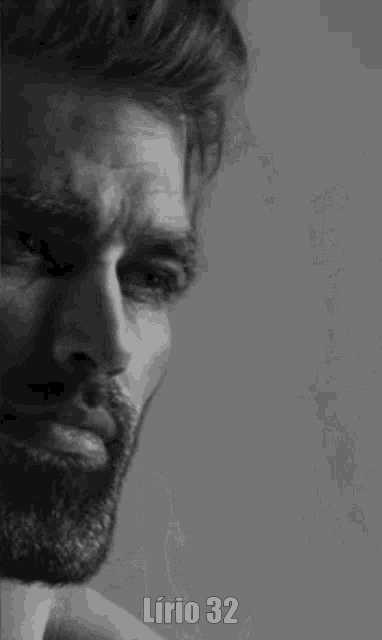 a black and white photo of a man with a beard and the words lirio 32 below him