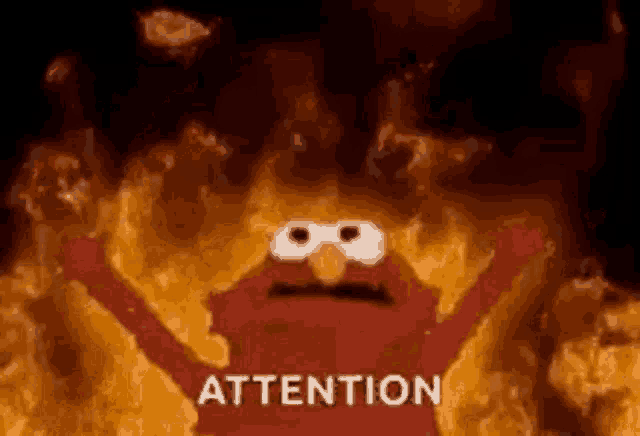 elmo from sesame street is standing in front of a fire with the words attention written on it .
