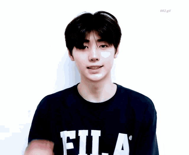 a young man wearing a black fila t-shirt