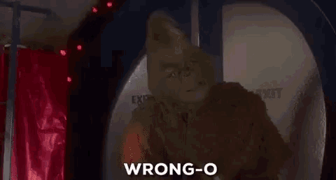 the grinch from the movie the grinch is standing in front of a christmas tree and says wrong-o .