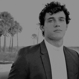 a black and white photo of a man in a suit and white shirt