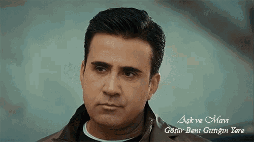 a close up of a man 's face with the words aşk ve mavi in the corner