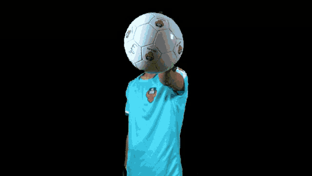 a soccer player wearing a blue jersey with a lion logo on the sleeve