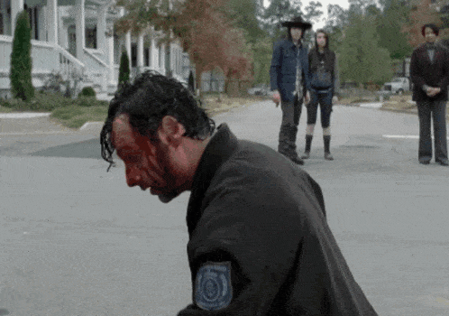 a man with blood on his face is wearing a black jacket with a patch that says " army " on it