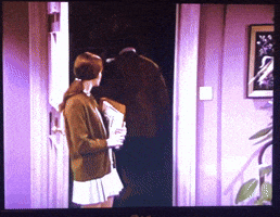 a man and a woman are standing in a doorway