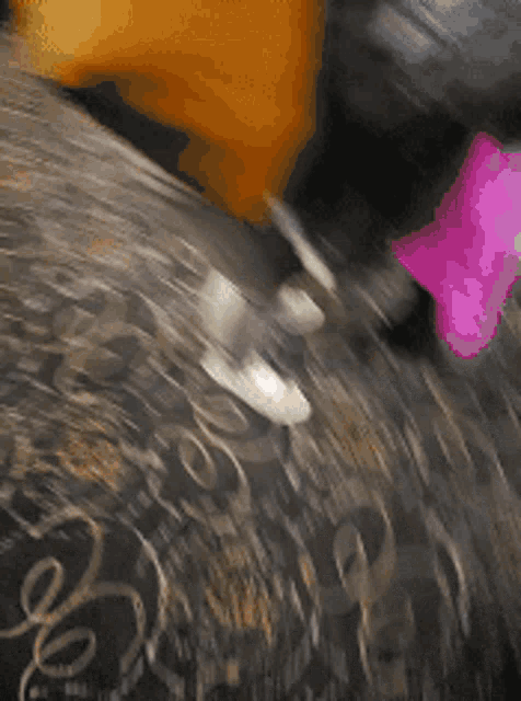 a blurry picture of a person 's feet with a pink boot in the foreground
