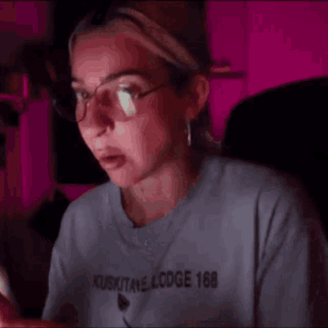 a woman wearing glasses and a shirt that says lodge 68 on it