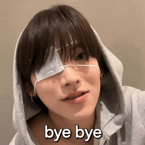 a woman with a bandage on her eye is wearing a hoodie and says " bye bye "