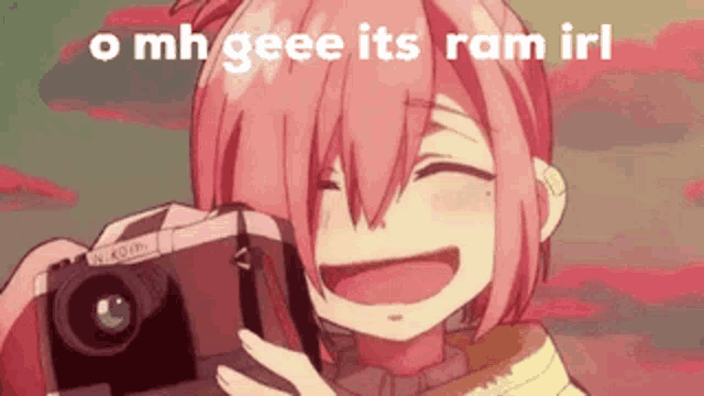 a girl with pink hair is smiling while holding a camera .