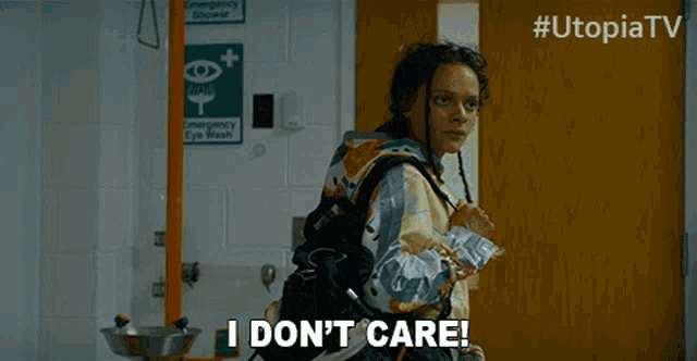 a woman says " i don 't care " in front of an emergency eye wash