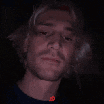 a close up of a man 's face with a red lip