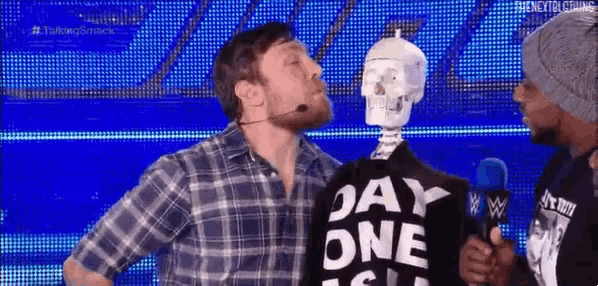a man in a plaid shirt is standing next to a skeleton wearing a shirt that says day one