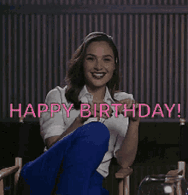 a woman is sitting in a chair with her legs crossed and the words happy birthday written above her .
