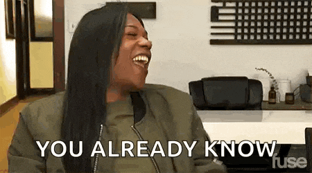 a woman is laughing and saying `` you already know '' while sitting in a chair .