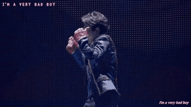 a person is dancing on a stage with the words i 'm a very bad boy written on the bottom