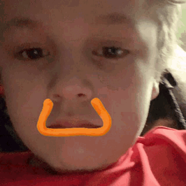 a close up of a child 's face with a drawing on it