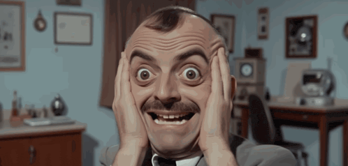 a man with a mustache is making a surprised face