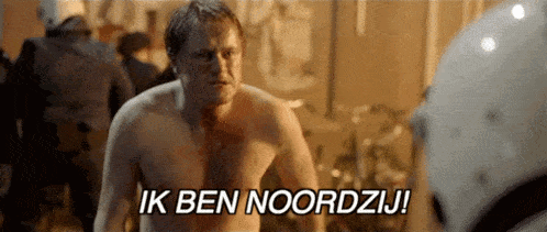 a shirtless man is standing in front of a group of people and says ik ben noordzij