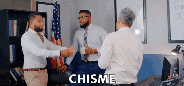 three men are standing in an office with the word chisme on the bottom right