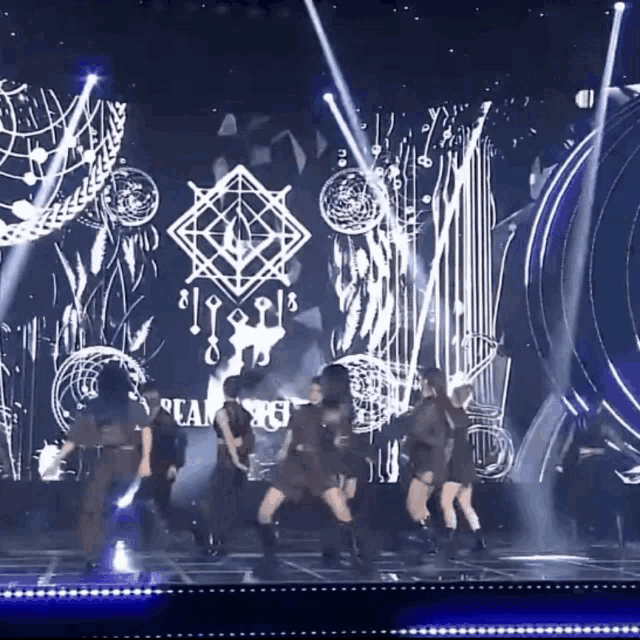 a group of people are dancing on a stage with a logo that says dreamcatcher