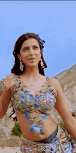 a woman in a crop top with a flower in her hair