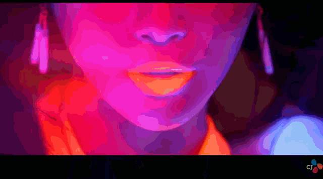a close up of a woman 's face with a cj logo behind her