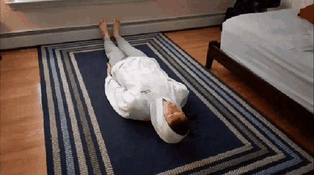a person laying on a rug with a bandage on their head and a white sweatshirt that says ' calvin klein '