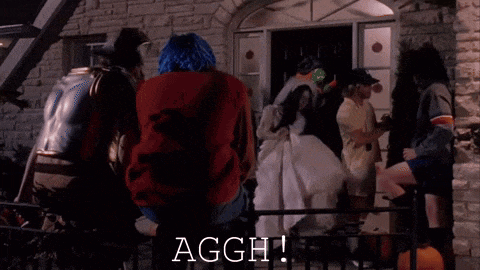 a group of people dressed in halloween costumes are gathered outside of a house and the word aggh is visible