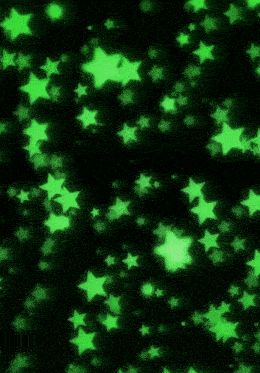 green stars on a black background that are glowing