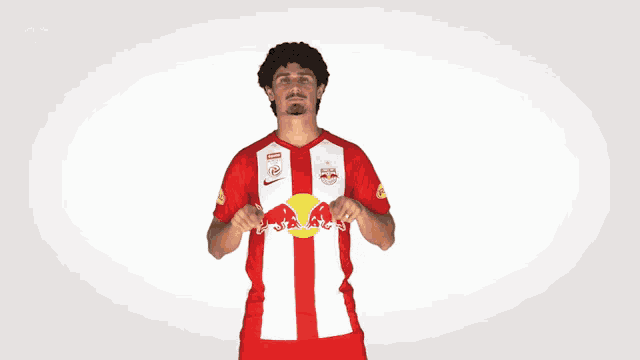 a man wearing a red and white jersey with red bulls on it