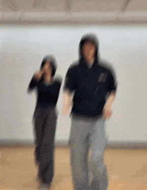 a blurry image of a man and woman dancing