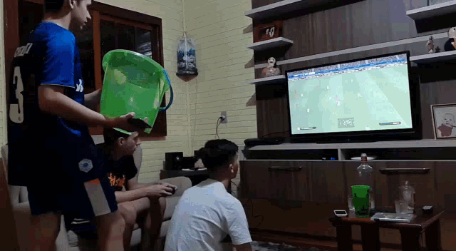 a group of people watching a soccer game on a television
