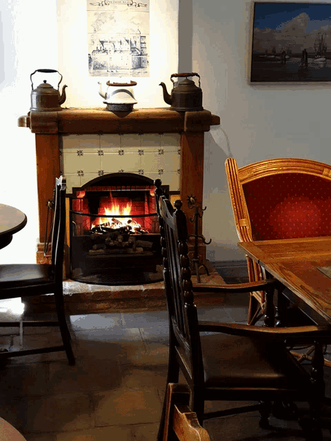 a fireplace in a room with a poster on the wall that says ' amsterdam ' on it