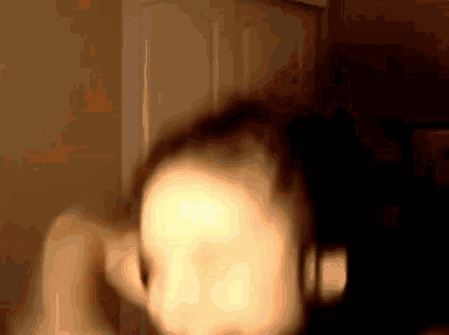 a blurred image of a person 's face with a few spots of light on it