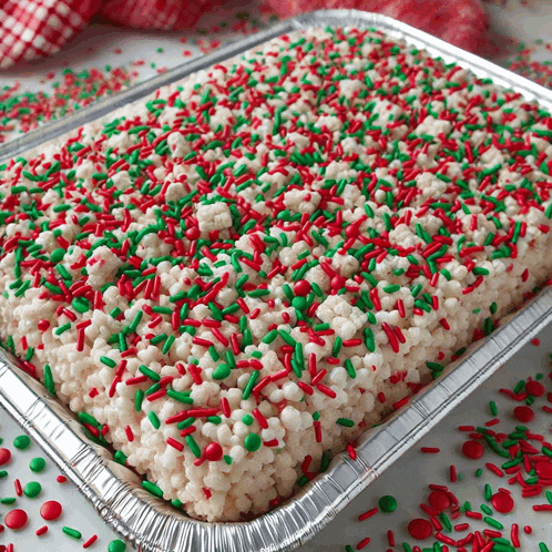 a tray of rice krispie treats with red and green sprinkles on top