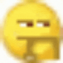 a close up of a yellow smiley face with a blurred background .