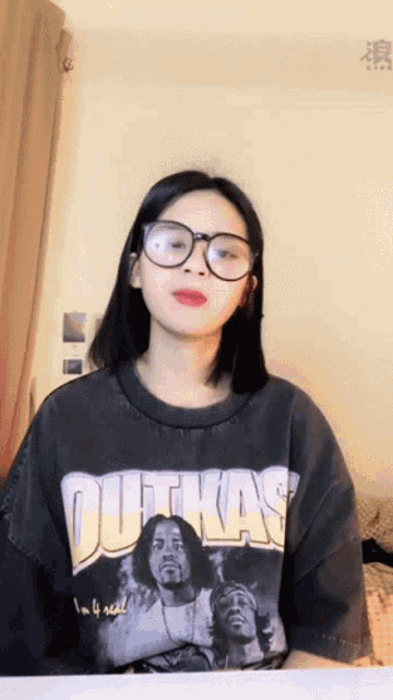 a woman wearing glasses and a shirt that says dutkas