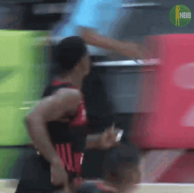 a blurry photo of a basketball player with the nbb logo on the bottom right