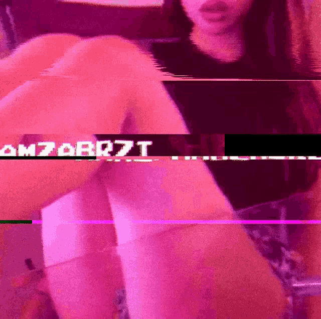 a woman is sitting on a couch with her legs crossed and the words om7abr7t on the bottom of the screen